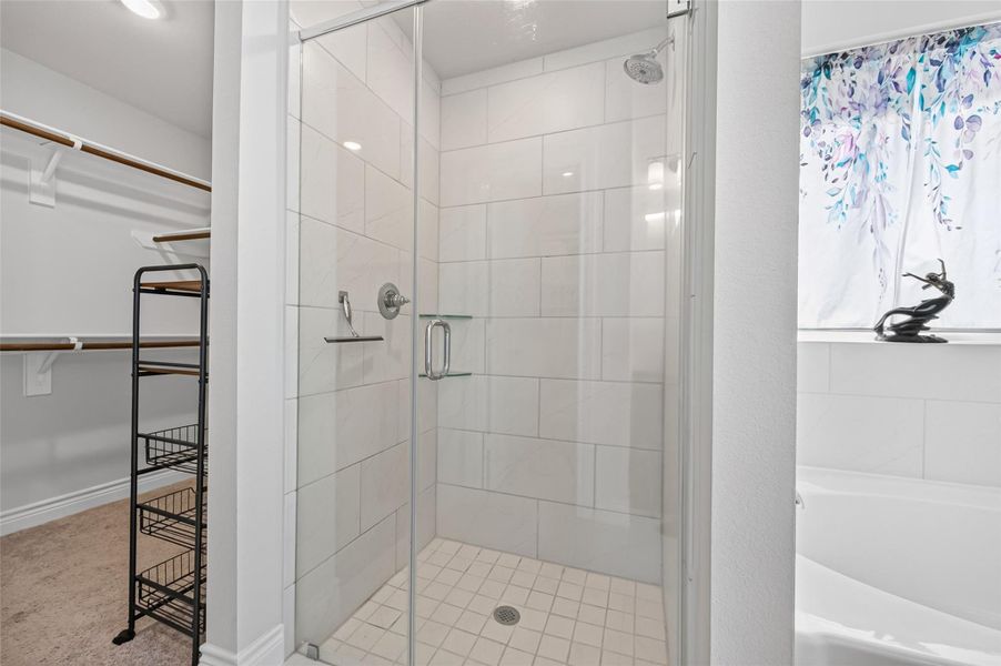 Experience the ultimate in comfort and convenience with this stunning primary suite addition. The primary bathroom features an expansive, extra-large walk-in shower finished with floor to ceiling designer tile, premium fixtures, and a sleek, modern seamless glass door. This spa-inspired space transitions effortlessly into a massive, oversized walk-in closet designed for maximum efficiency, complete with custom shelving and tailored organizational systems that perfectly complement a luxury lifestyle. Experience the ultimate in comfort and convenience with this stunning primary suite addition. The primary bathroom features an expansive, extra-large walk-in shower finished with floor to ceiling designer tile, premium fixtures, and a sleek, modern seamless glass door. This spa-inspired space transitions effortlessly into a massive, oversized walk-in closet designed for maximum efficiency, complete with custom shelving and tailored organizational systems that perfectly complement a luxury lifestyle.