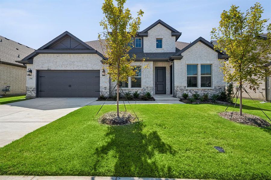 Front exterior of a new home in Elevon, Lavon, TX, highlighting curb appeal (Image 2). Front exterior of a new home in Elevon, Lavon, TX, highlighting curb appeal (Image 2).