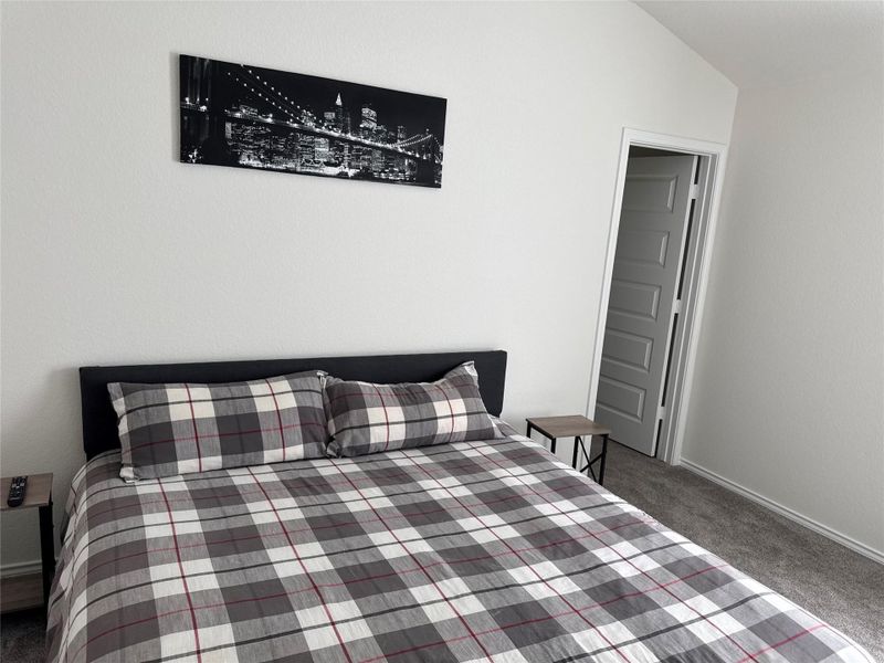 A comfortable bedroom with a vaulted ceiling provides a serene retreat.