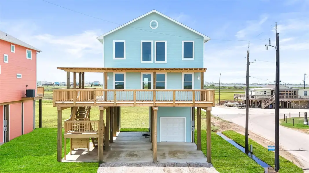 This new construction coastal home features a bright, modern exterior with large windows, a spacious deck, and an open garage beneath. Ideal for enjoying scenic views and seaside living. This new construction coastal home features a bright, modern exterior with large windows, a spacious deck, and an open garage beneath. Ideal for enjoying scenic views and seaside living.