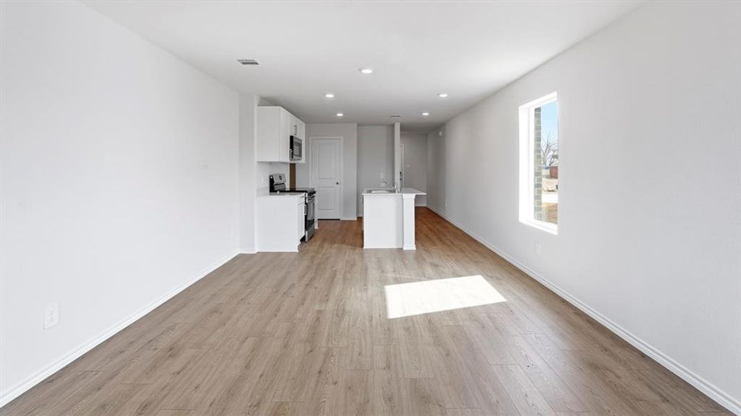 Unfurnished living room with light wood-style flooring and recessed lighting