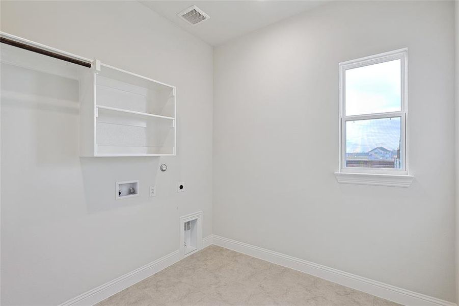 Laundry area featuring gas dryer hookup, washer hookup, and electric dryer hookup Laundry area featuring gas dryer hookup, washer hookup, and electric dryer hookup