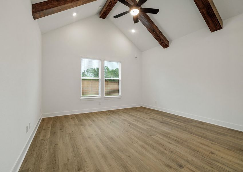 The primary bedroom includes beam accents. The primary bedroom includes beam accents.