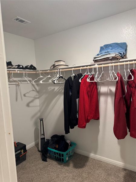Walk in closet featuring light carpet