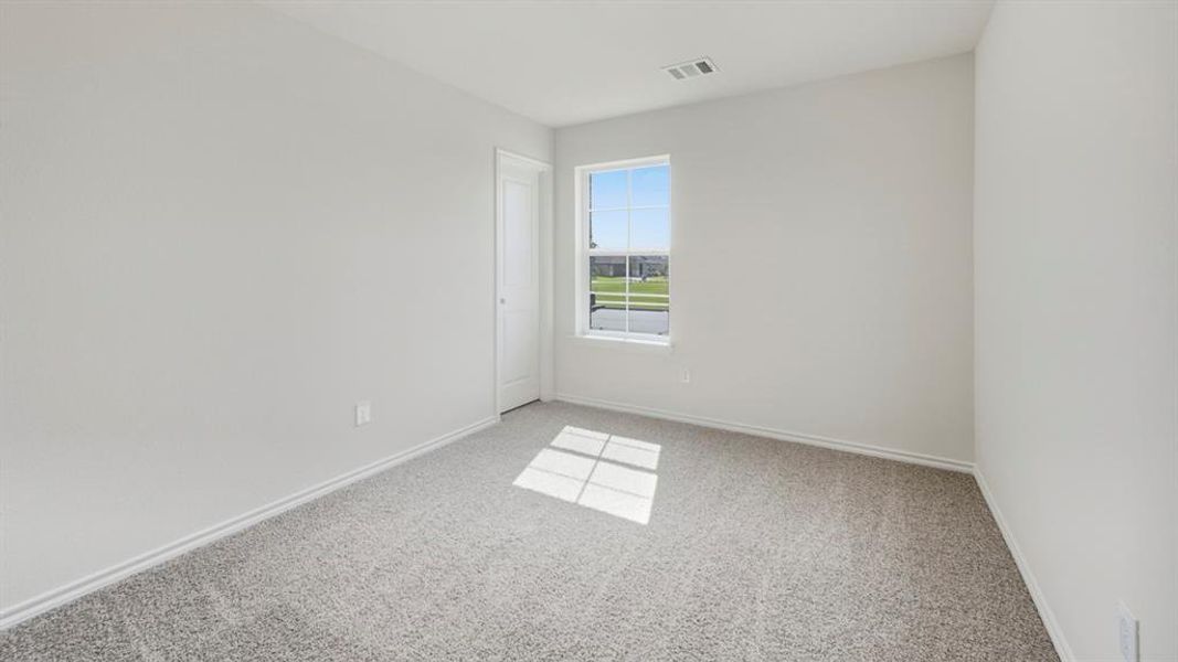 Spare room with baseboards and light carpet