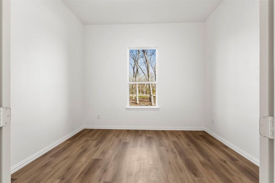 Spare room featuring dark wood-type flooring