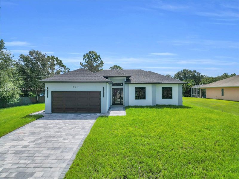 Front exterior of a new home in , Lehigh Acres, FL, highlighting curb appeal (Image 16). Front exterior of a new home in , Lehigh Acres, FL, highlighting curb appeal (Image 16).