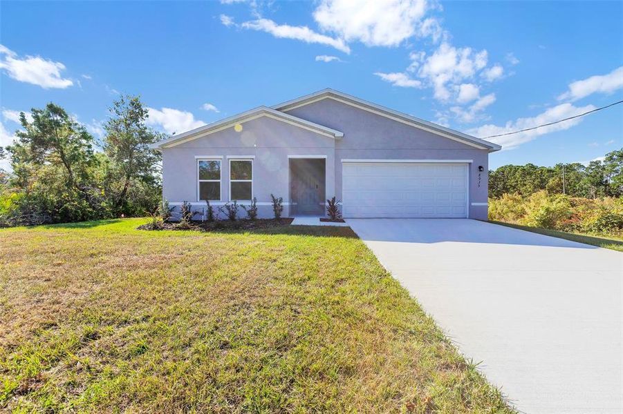 Front exterior of a new home in Palm Bay Classic, Palm Bay, FL, highlighting curb appeal (Image 11).