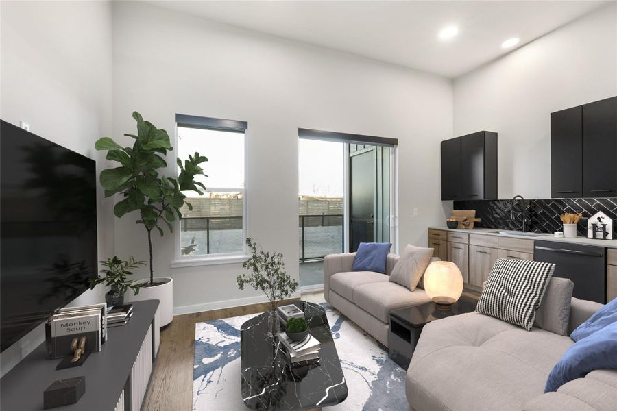 Living room featuring baseboards, light wood-style floors, and recessed lighting