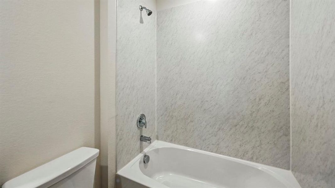 Bathroom with shower / bath combination and toilet