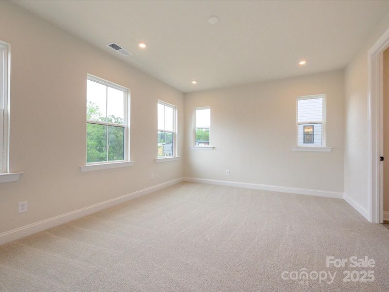 Primary Suite Surrounded By Bright Windows.