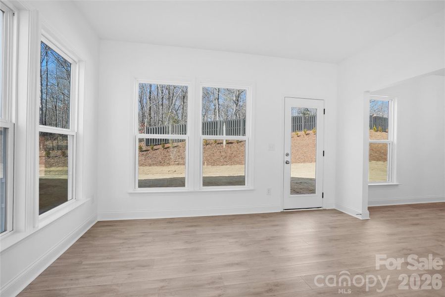 Light filled sunroom is open to gathering room and cafe