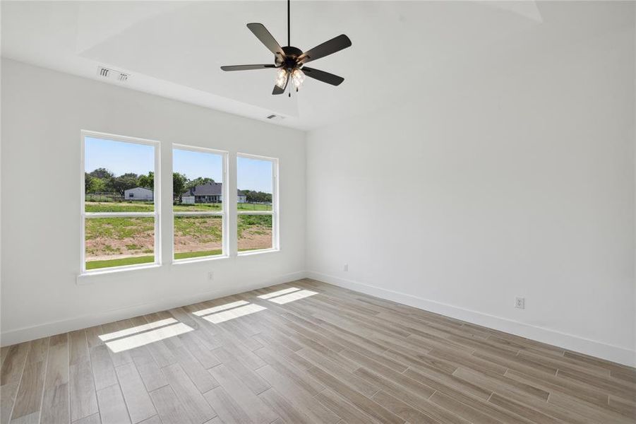 Spare room with ceiling fan and light hardwood / wood-style floors