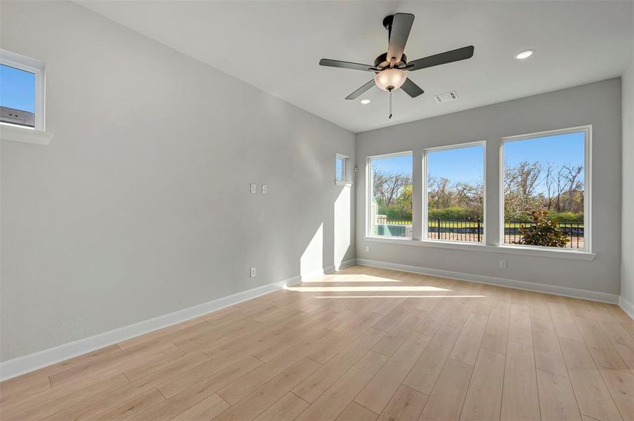 Unfurnished room with ceiling fan, light wood-style flooring, and recessed lighting Unfurnished room with ceiling fan, light wood-style flooring, and recessed lighting