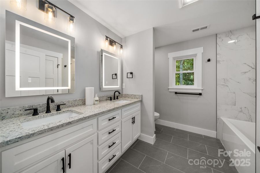 Upper level hall bath with smart mirrors offering defog and custom lighting features at the touch of a button