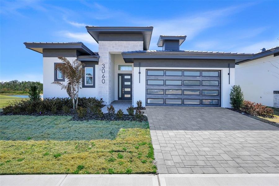 Front exterior of a new home in Hampton Green at Providence, Davenport, FL, highlighting curb appeal (Image 20).