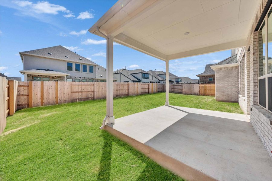 Fenced backyard featuring a patio area and a residential view Fenced backyard featuring a patio area and a residential view
