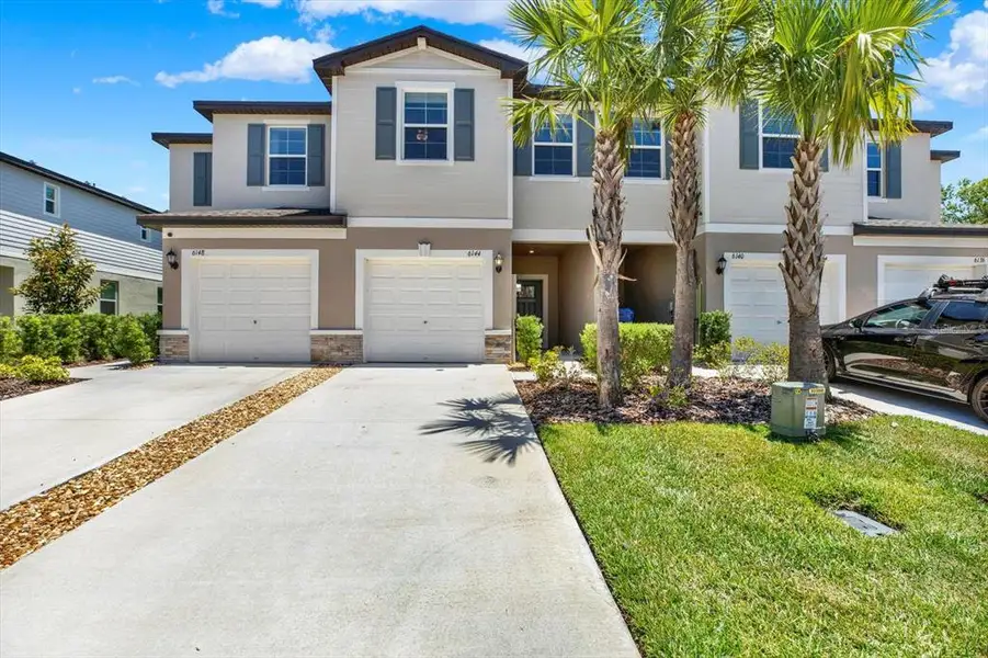 Front exterior of a new home in , Land O' Lakes, FL, highlighting curb appeal (Image 1). Front exterior of a new home in , Land O' Lakes, FL, highlighting curb appeal (Image 1).