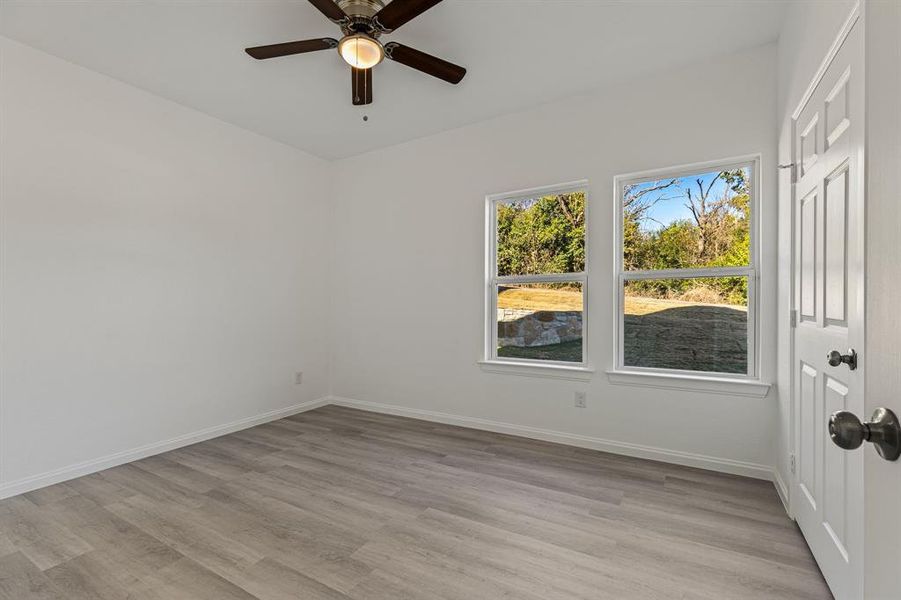 Spare room featuring light wood-type flooring and a ceiling fan