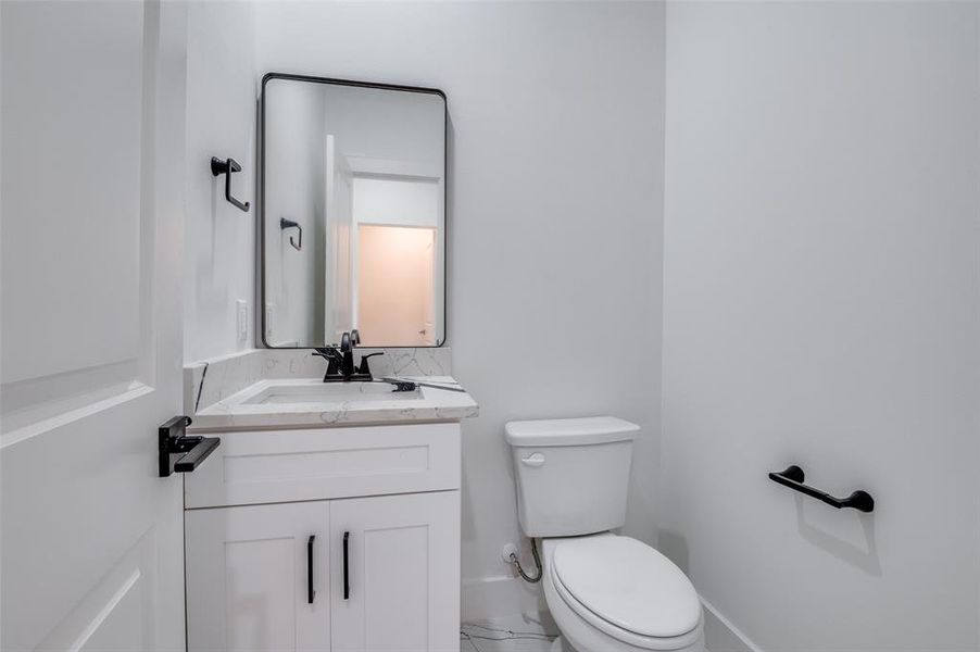 Half bath with toilet and vanity Half bath with toilet and vanity