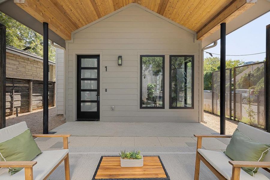 Sunroom featuring a patio and lofted ceiling