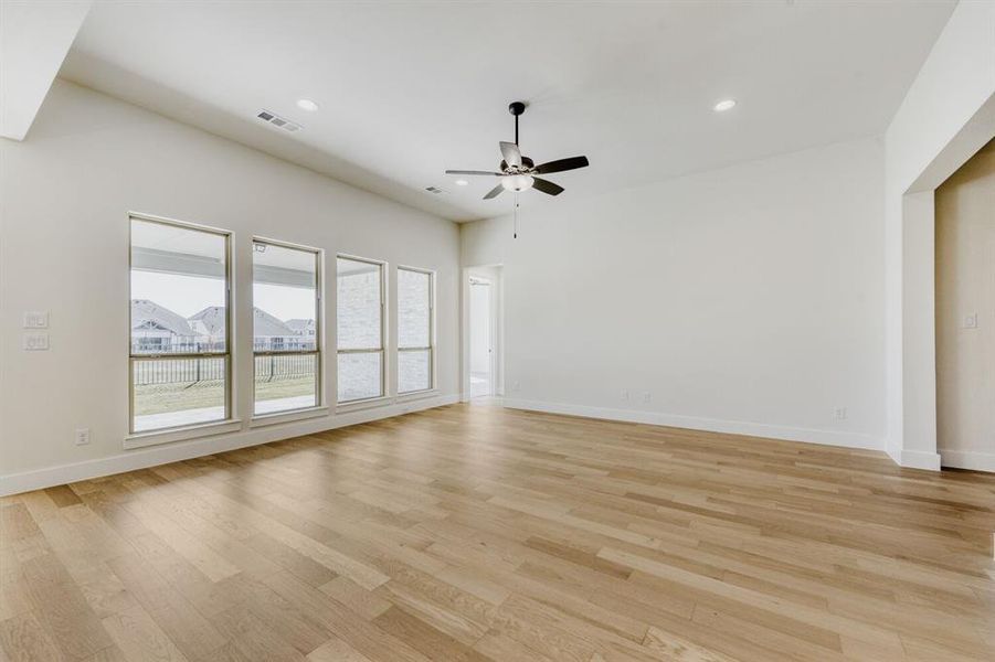 Spare room featuring a ceiling fan, light wood-type flooring, and recessed lighting