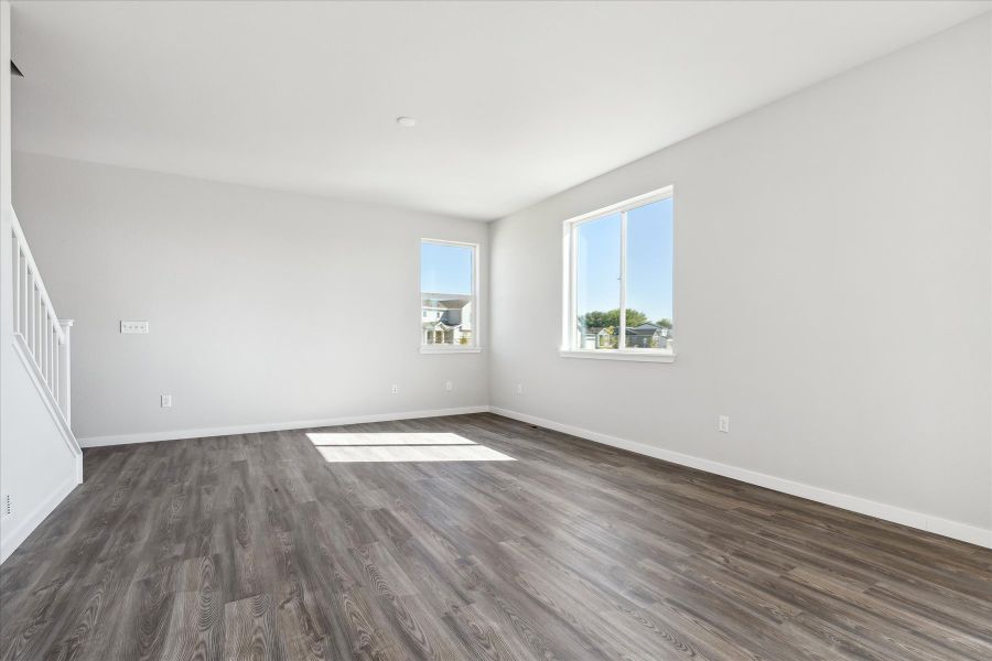 A room with windows and wood floors.