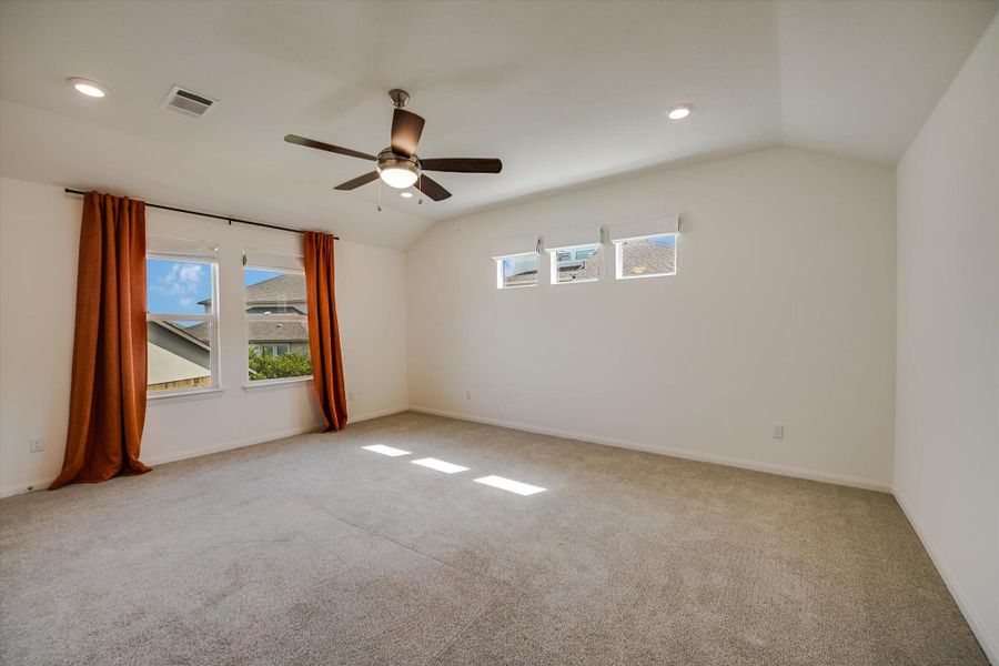 Spare room with lofted ceiling, carpet flooring, recessed lighting, and a ceiling fan Spare room with lofted ceiling, carpet flooring, recessed lighting, and a ceiling fan