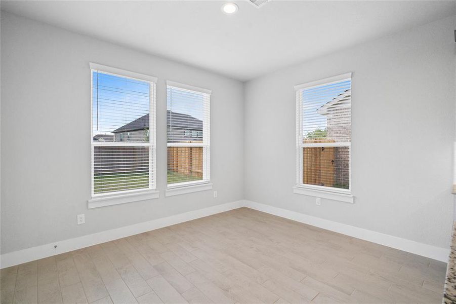 Start your day off right with a cup of coffee sitting with your family in the lovely breakfast area! Featuring large windows with blinds, custom paint and gorgeous flooring.