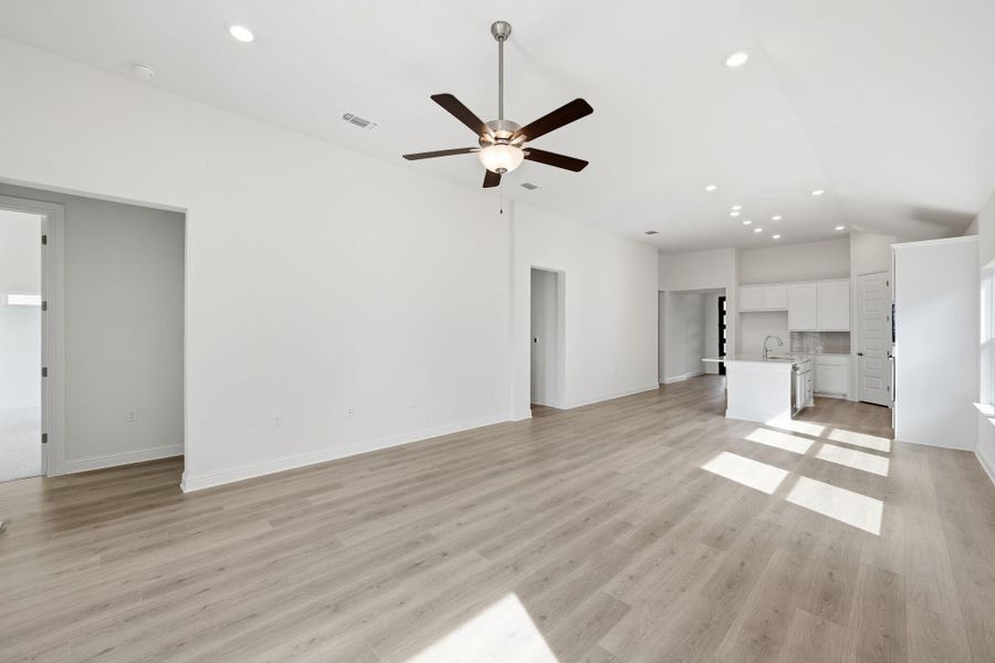 Unfurnished living room featuring recessed lighting, light wood finished floors, and a ceiling fan Unfurnished living room featuring recessed lighting, light wood finished floors, and a ceiling fan