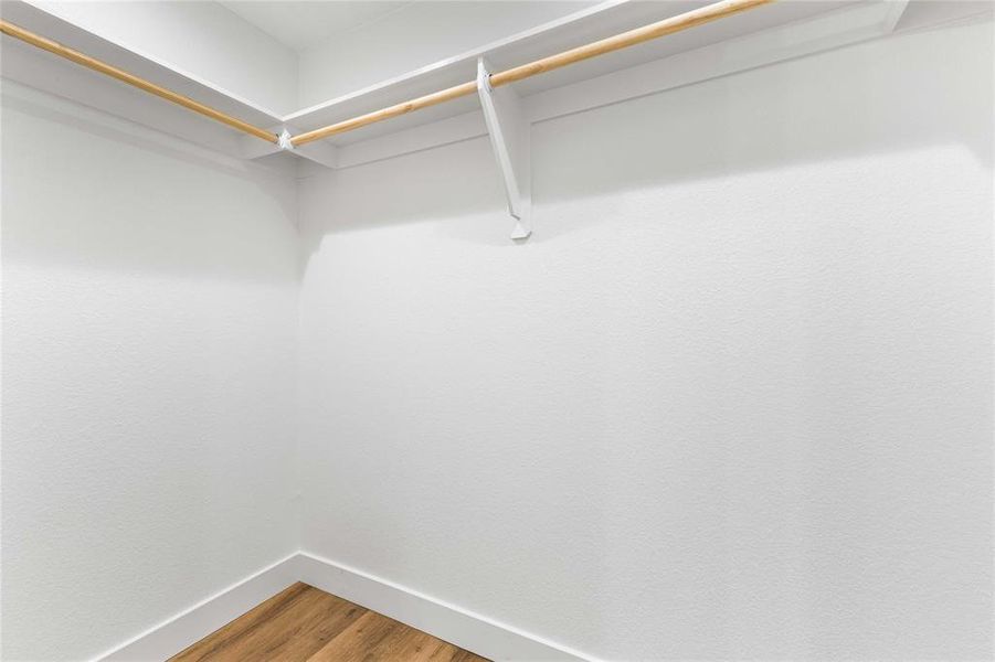 Spacious closet with wood finished floors Spacious closet with wood finished floors
