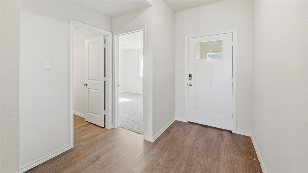 Foyer entrance featuring baseboards and wood finished floors