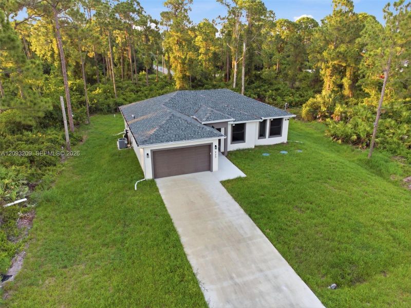 Front exterior of a new home in , Lehigh Acres, FL, highlighting curb appeal (Image 27).