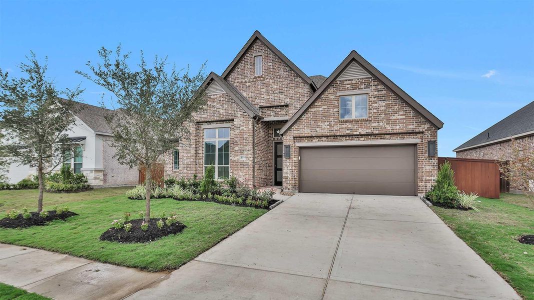 Front exterior of a new home in Serenity 55+ Active Adult, Arcola, TX, highlighting curb appeal (Image 1).