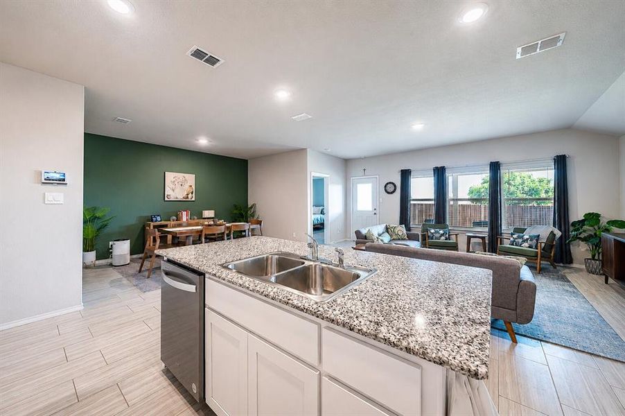 Kitchen island with a granite countertop and dual stainless steel sinks