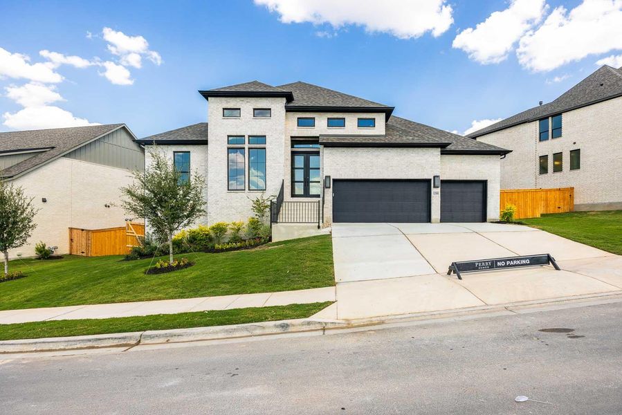 Prairie-style home featuring a shingled roof, concrete driveway, and an attached garage