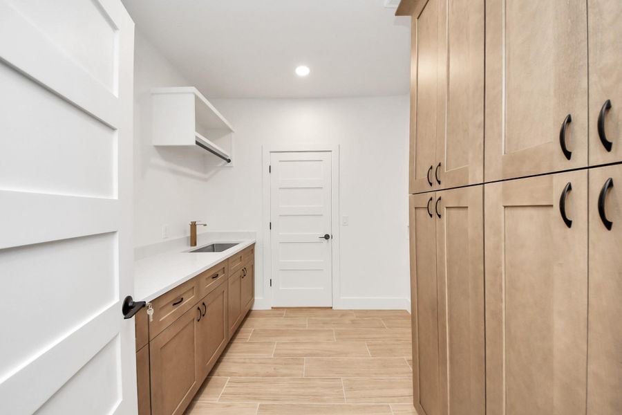 Functional utility room, with storage, sink, and countertop space