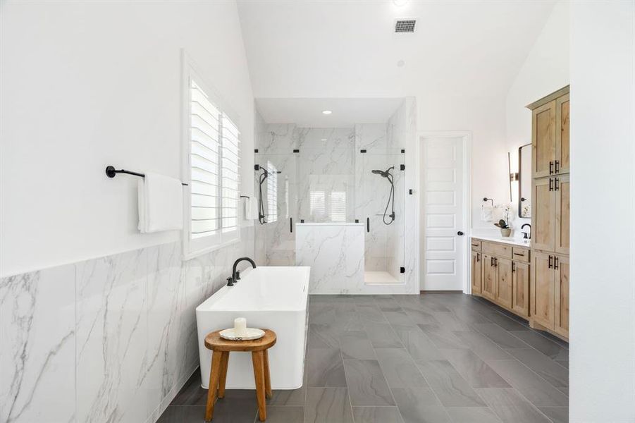 A breathtaking primary retreat boasting a contemporary freestanding tub, a grand double-sided shower, and an oversized walk-in closet.