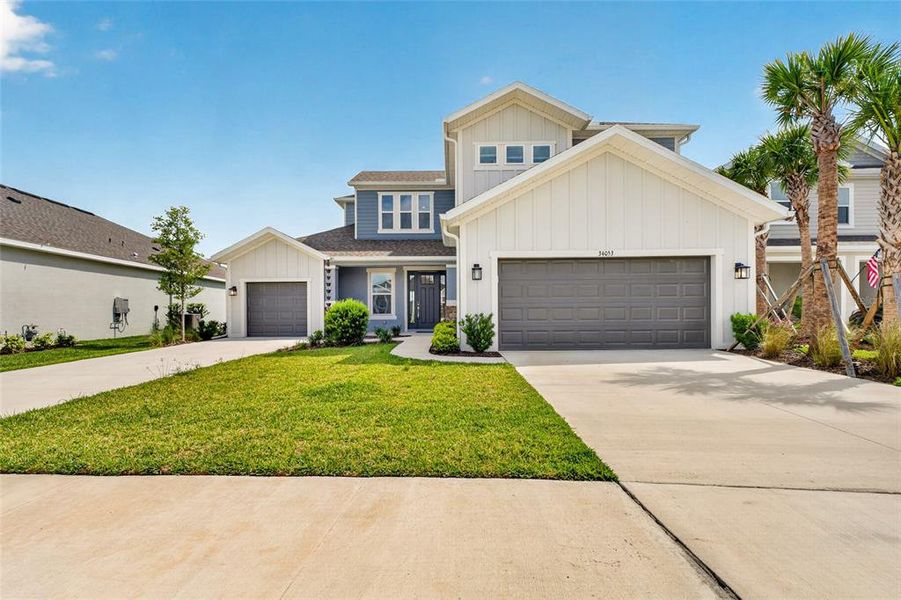 Front exterior of a new home in River Landing, Wesley Chapel, FL, highlighting curb appeal (Image 2). Front exterior of a new home in River Landing, Wesley Chapel, FL, highlighting curb appeal (Image 2).