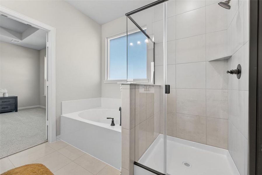 Full bathroom with a bath, a stall shower, light carpet, and light tile patterned floors Full bathroom with a bath, a stall shower, light carpet, and light tile patterned floors