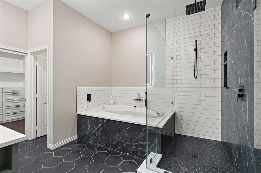 Full bath with a shower stall, a bath, dark tile patterned flooring, and vanity Full bath with a shower stall, a bath, dark tile patterned flooring, and vanity