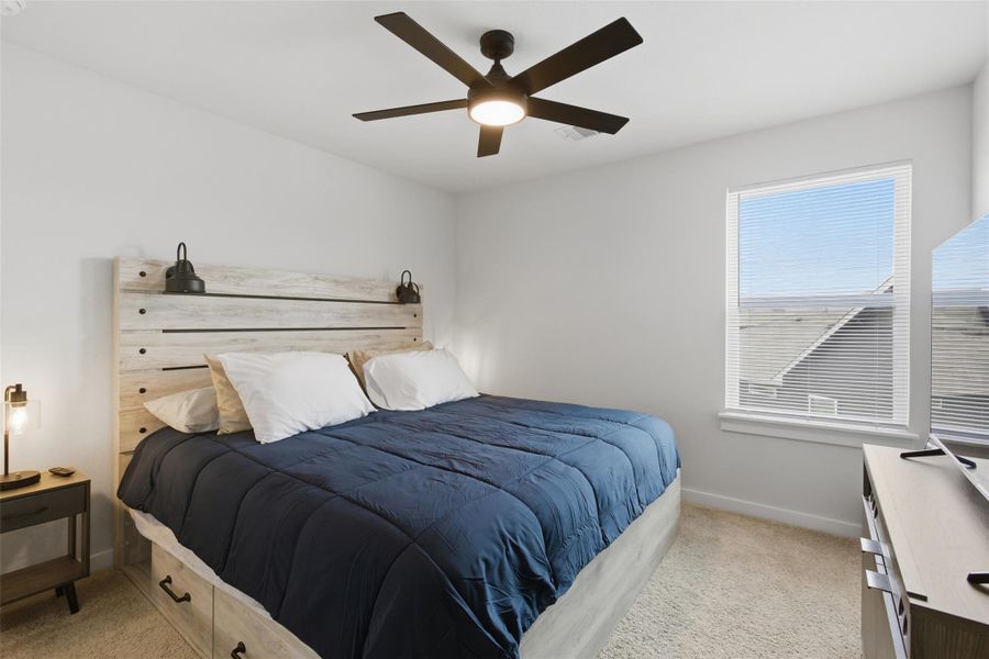 Bedroom with light carpet and ceiling fan