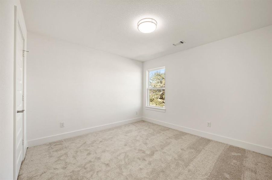 Unfurnished room with light carpet and baseboards