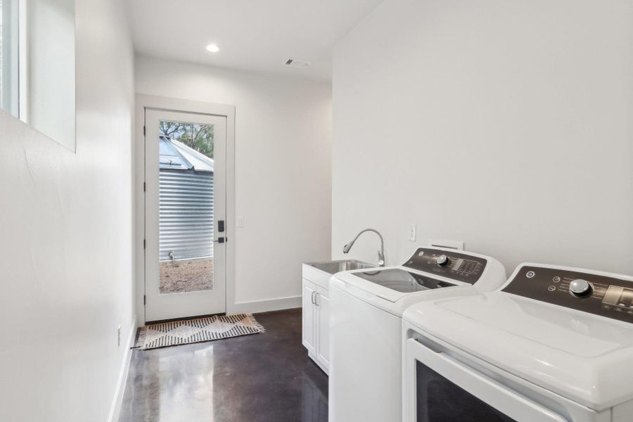Washroom with washing machine and clothes dryer, cabinet space, baseboards, and recessed lighting Washroom with washing machine and clothes dryer, cabinet space, baseboards, and recessed lighting