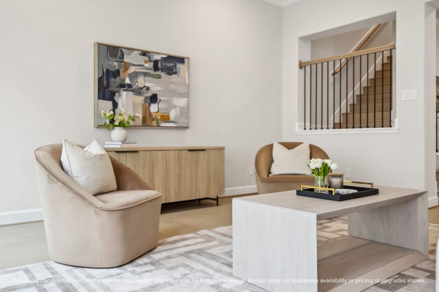 Light-Filled Elegance. The open-concept living area is designed for comfort, featuring soaring ceilings, stylish finishes, and seamless flow.