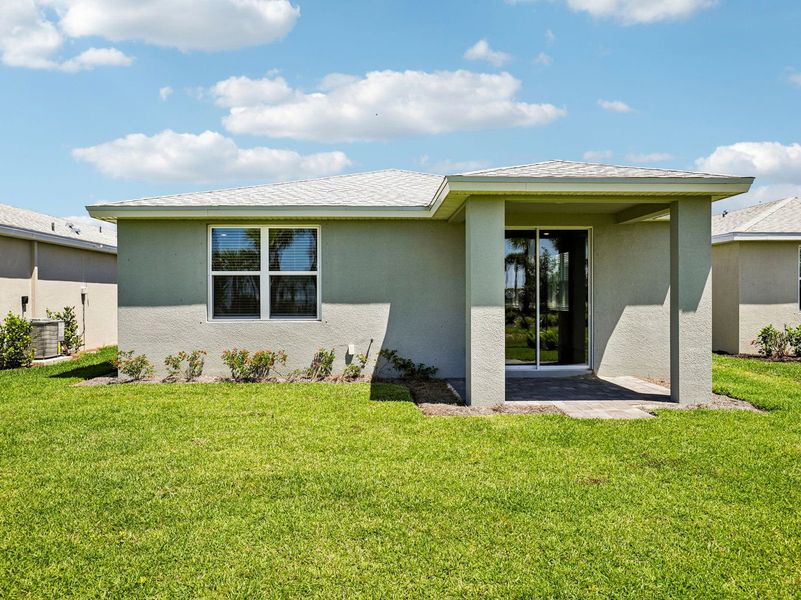 Exterior details and patio area of a home in Crescent Lakes - Premier Series, Punta Gorda (Image 3).