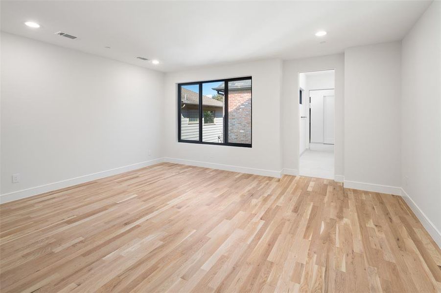 Empty room with light hardwood / wood-style floors