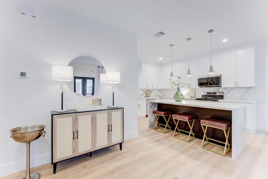 The quartz island kitchen and pendant lighting is the perfect place to entertain.