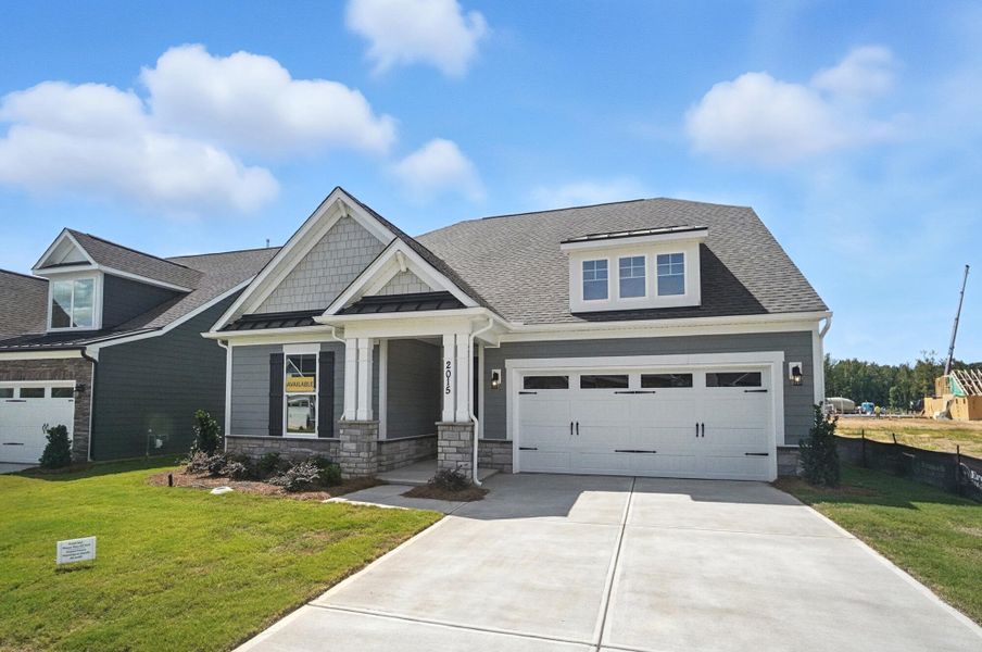 Front exterior of a new home in Heritage - 55+ Community, Indian Trail, NC, highlighting curb appeal (Image 23). Front exterior of a new home in Heritage - 55+ Community, Indian Trail, NC, highlighting curb appeal (Image 23).