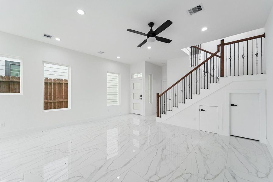 View from kitchen looking at upgraded staircase and living room View from kitchen looking at upgraded staircase and living room